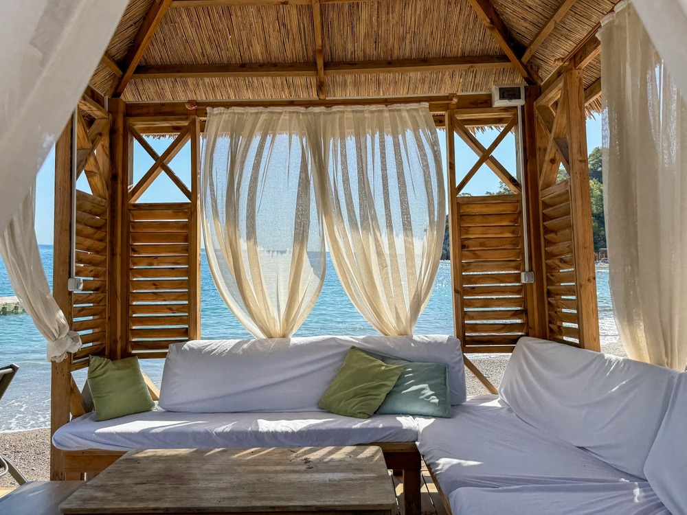 Luxury beach cabana with daybed and curtains by leading Cabanas & Daybeds manufacturer in India